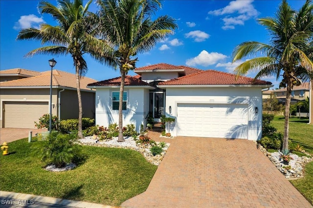 view of front of house featuring a garage, decorative driveway, and stucco siding