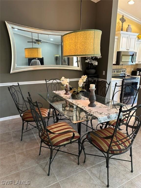 dining area featuring light tile patterned floors, baseboards, crown molding, and recessed lighting