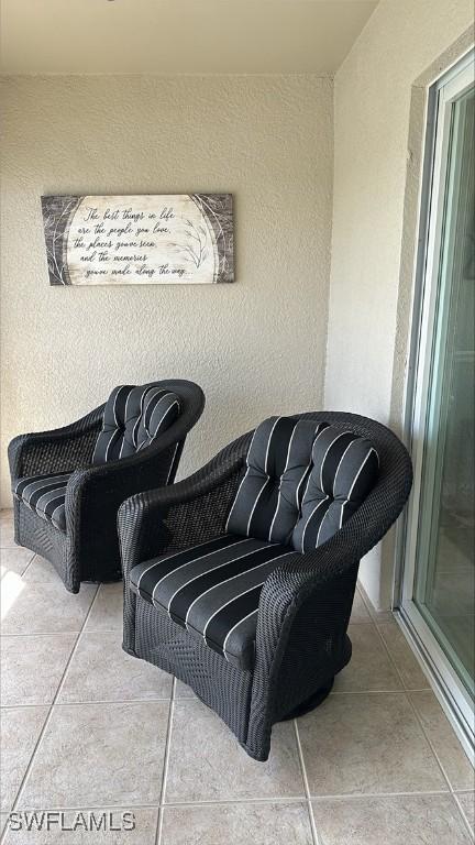 living area with tile patterned floors