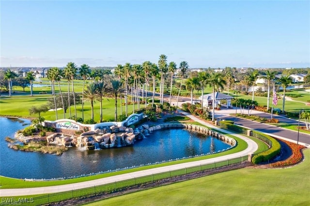 view of home's community featuring a water view and a yard