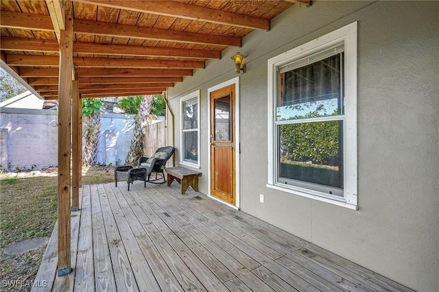 wooden terrace featuring fence