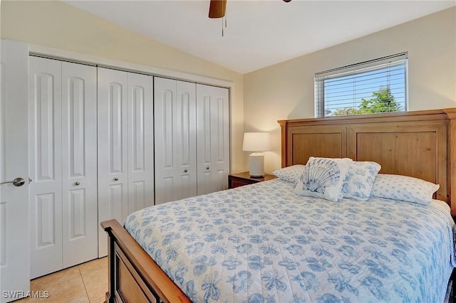 bedroom with light tile patterned floors, ceiling fan, a closet, and vaulted ceiling