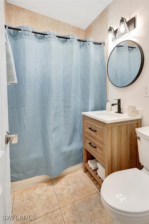 bathroom with vanity, toilet, and tile patterned floors