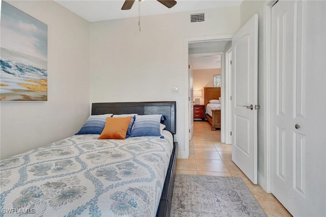 bedroom featuring light tile patterned floors, ceiling fan, and visible vents