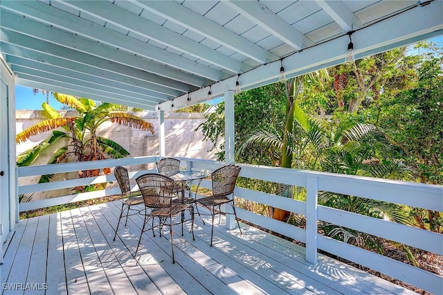 wooden deck featuring outdoor dining area and fence