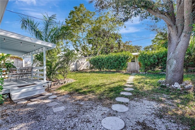 view of yard featuring fence and a deck