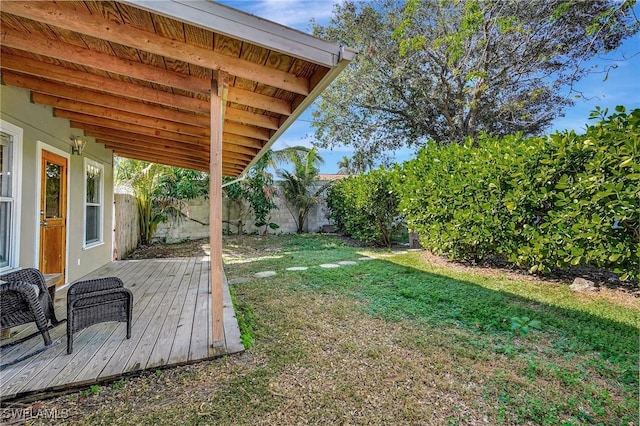 view of yard with a fenced backyard and a deck