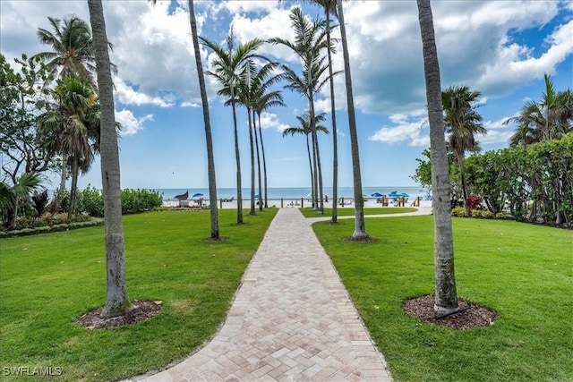 view of community featuring a yard and a water view