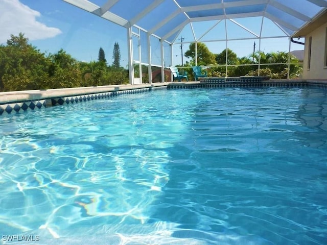 view of swimming pool with a lanai