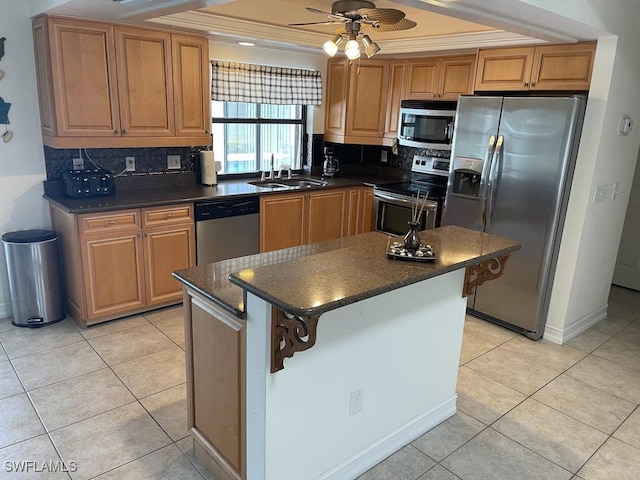 kitchen featuring a breakfast bar, sink, tasteful backsplash, a kitchen island, and stainless steel appliances