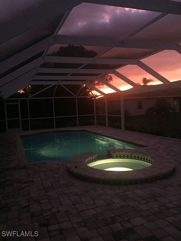 view of swimming pool featuring an in ground hot tub