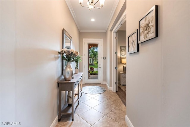 entryway featuring crown molding, light tile patterned floors, and an inviting chandelier