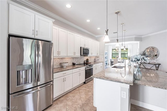 kitchen with sink, white cabinetry, hanging light fixtures, a center island with sink, and stainless steel appliances