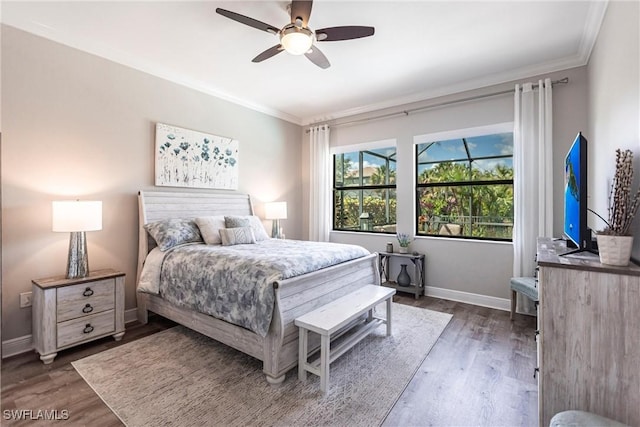 bedroom featuring dark wood-type flooring, ceiling fan, and ornamental molding