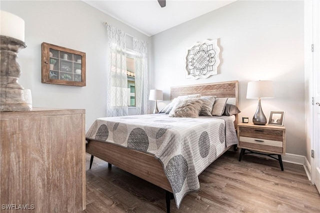 bedroom featuring wood-type flooring and ceiling fan