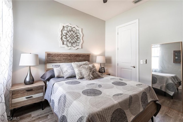 bedroom with dark wood-type flooring