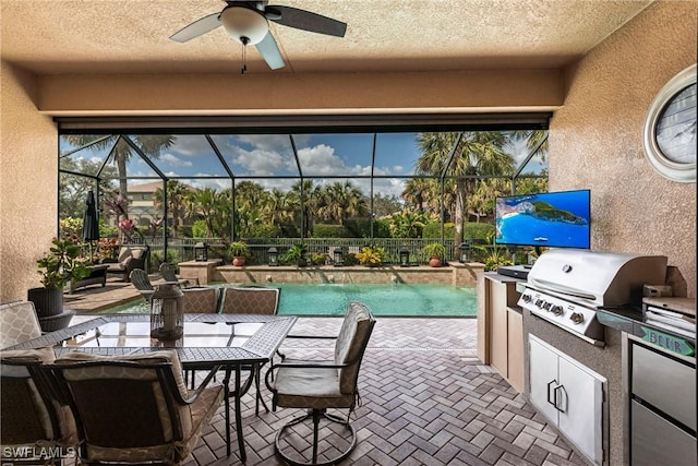 view of patio with area for grilling, pool water feature, ceiling fan, glass enclosure, and a fenced in pool