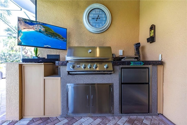 view of patio / terrace with an outdoor kitchen and a grill