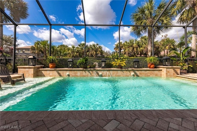 view of pool featuring pool water feature and glass enclosure