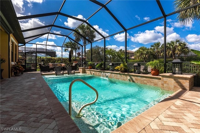 view of pool featuring pool water feature, outdoor lounge area, glass enclosure, and a patio area