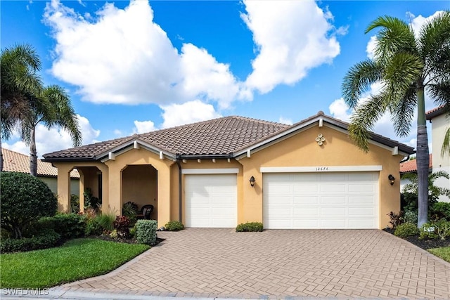 mediterranean / spanish-style house with a garage