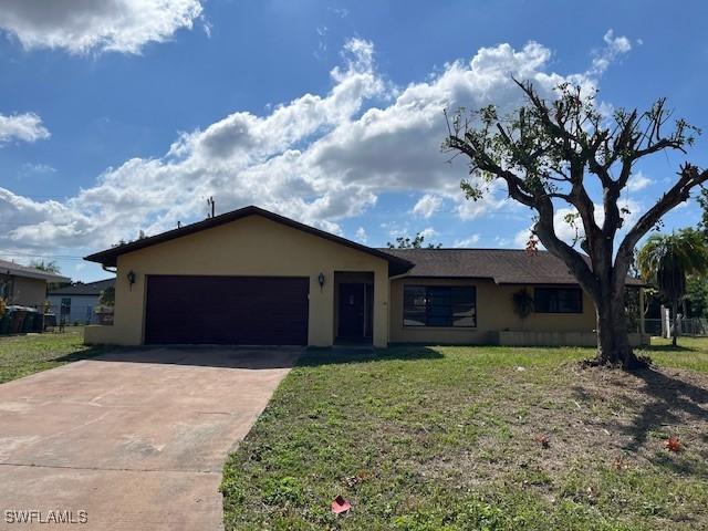 ranch-style house with a garage and a front yard