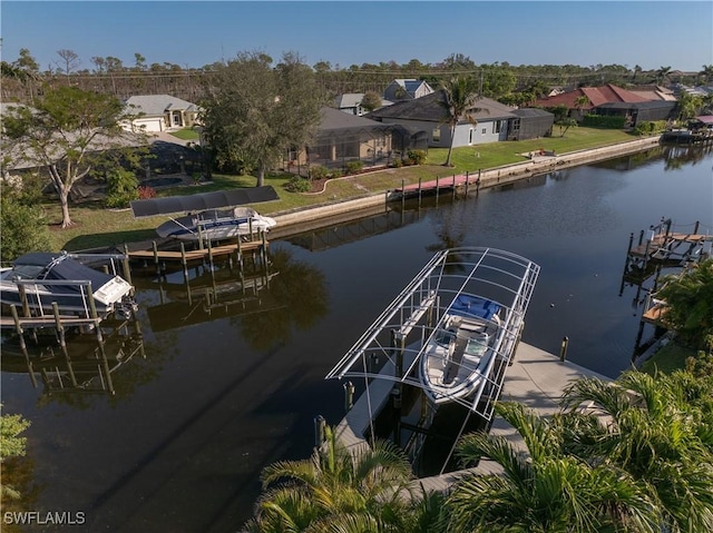 view of dock featuring a residential view, boat lift, and a water view