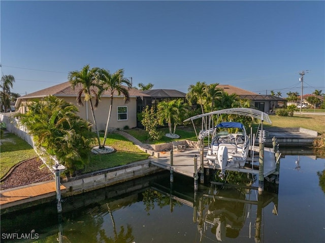 view of dock with glass enclosure, a lawn, a water view, and boat lift