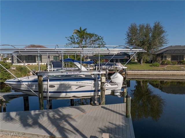 dock area with a water view and boat lift