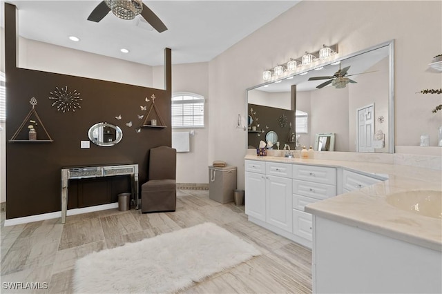 bathroom with vanity, a ceiling fan, and baseboards