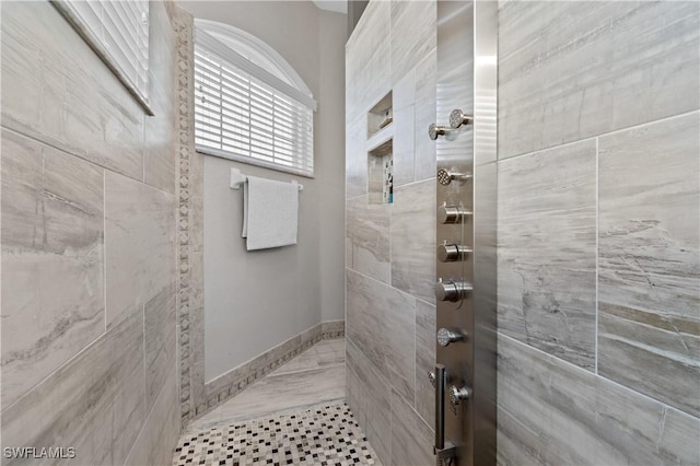 bathroom with tiled shower