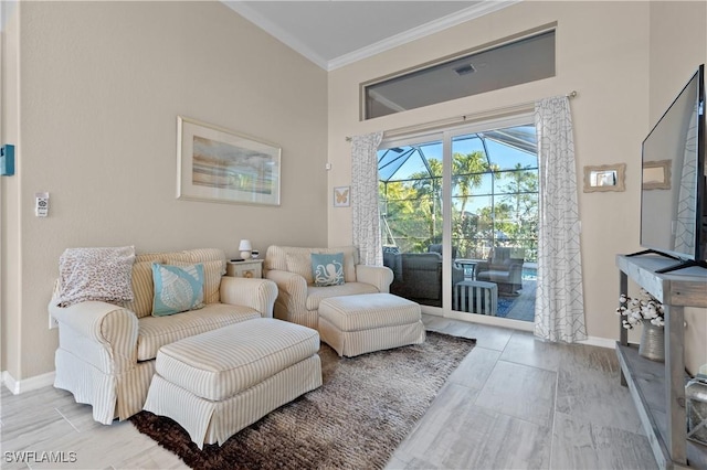 sitting room with baseboards and crown molding