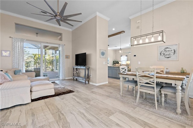 living room with visible vents, crown molding, baseboards, and a towering ceiling