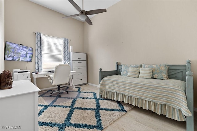 bedroom with baseboards, lofted ceiling, and ceiling fan