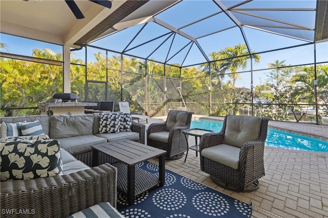 view of patio / terrace featuring glass enclosure, ceiling fan, an outdoor pool, and an outdoor hangout area