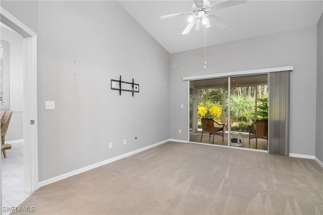 empty room featuring ceiling fan, high vaulted ceiling, and light carpet