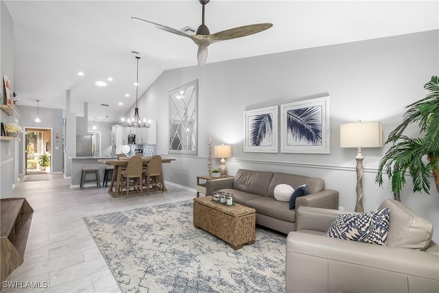 living room with lofted ceiling and ceiling fan with notable chandelier