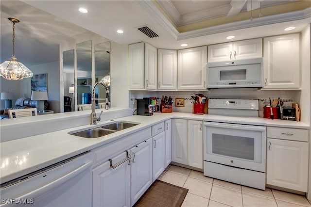 kitchen featuring sink, white appliances, decorative light fixtures, and white cabinets