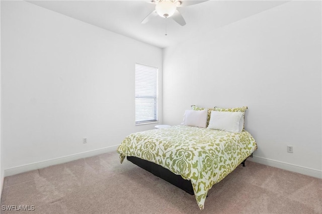 carpeted bedroom with baseboards and a ceiling fan