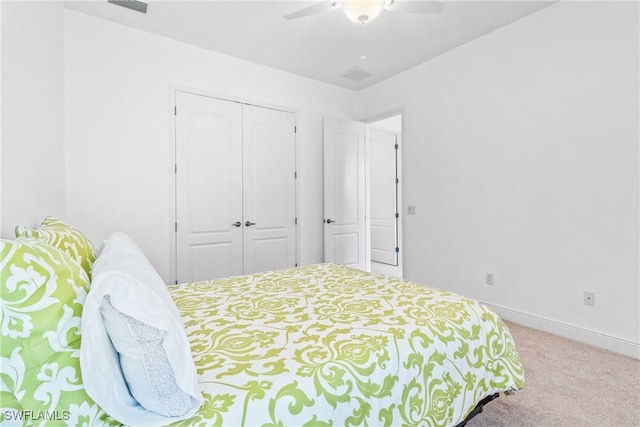 bedroom featuring ceiling fan, visible vents, baseboards, a closet, and carpet