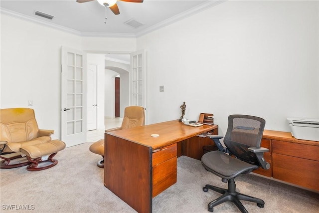 office featuring light carpet, visible vents, arched walkways, and ornamental molding