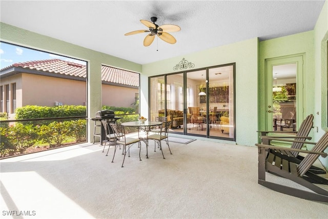 sunroom / solarium with a ceiling fan