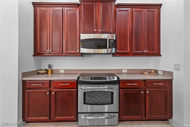 kitchen with appliances with stainless steel finishes, light countertops, and dark brown cabinets