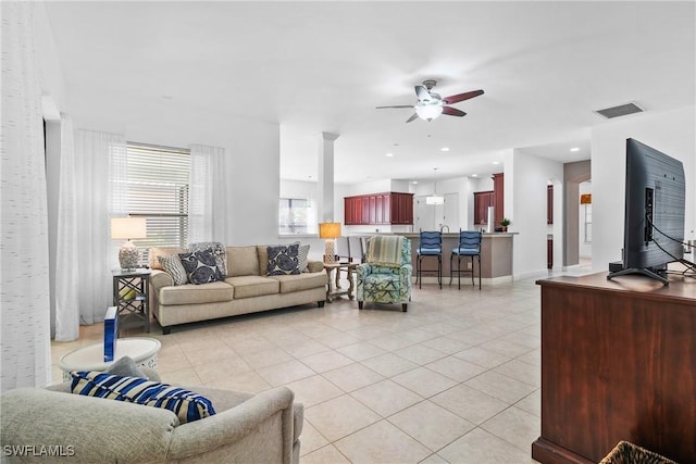 living area with light tile patterned floors, ceiling fan, recessed lighting, visible vents, and baseboards