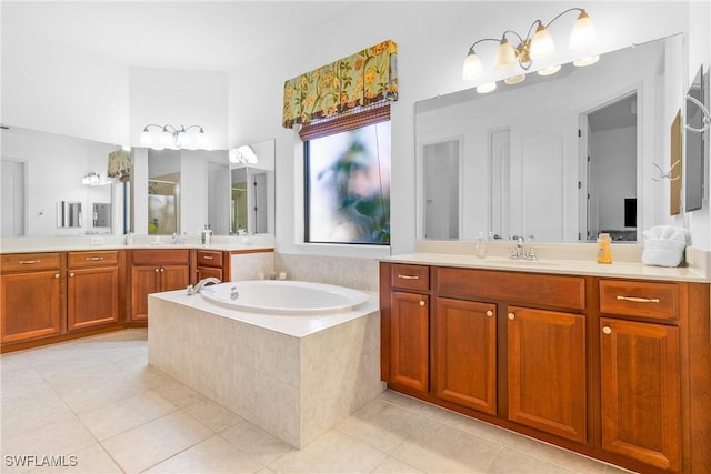 bathroom featuring a stall shower, vanity, a bath, and tile patterned floors