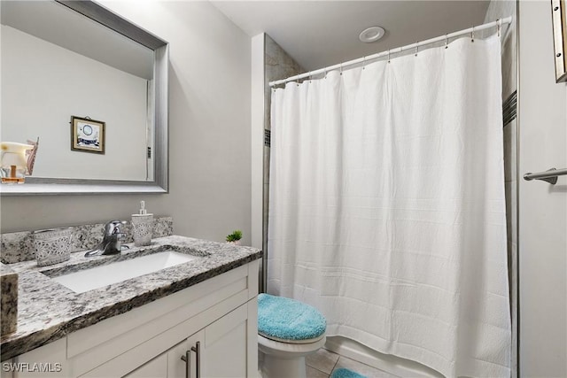 bathroom featuring vanity, toilet, and a shower with shower curtain