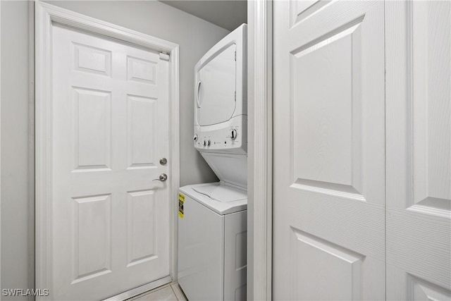 laundry room with stacked washer / drying machine