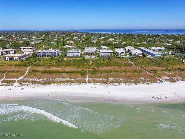 drone / aerial view with a beach view and a water view