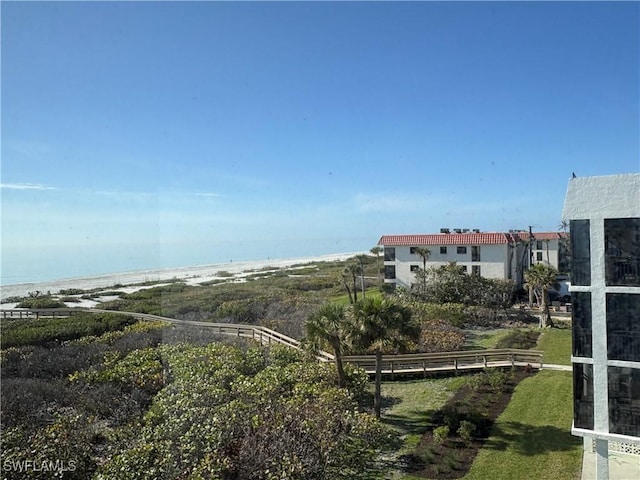 exterior space with a water view and a view of the beach