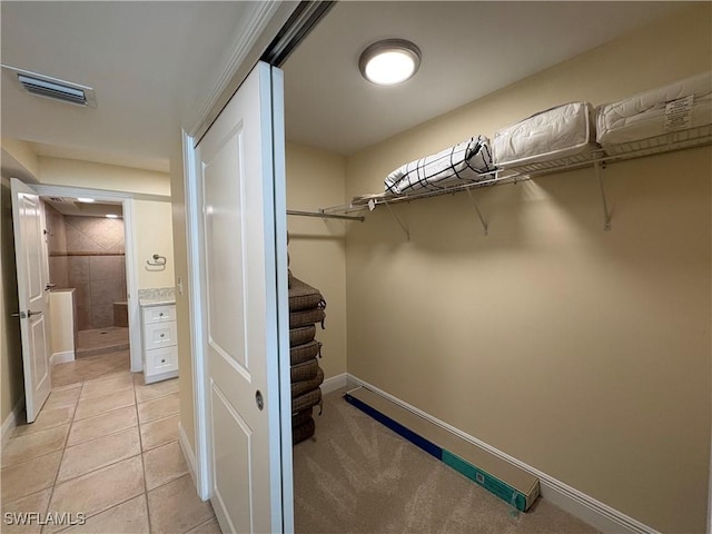 spacious closet featuring light tile patterned floors